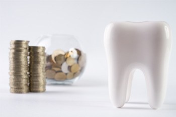 Tooth next to a jar of coins